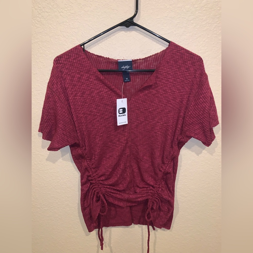 Brand new maroon, cinched with drawstring, v-neck BUCKLE shirt. Size medium.